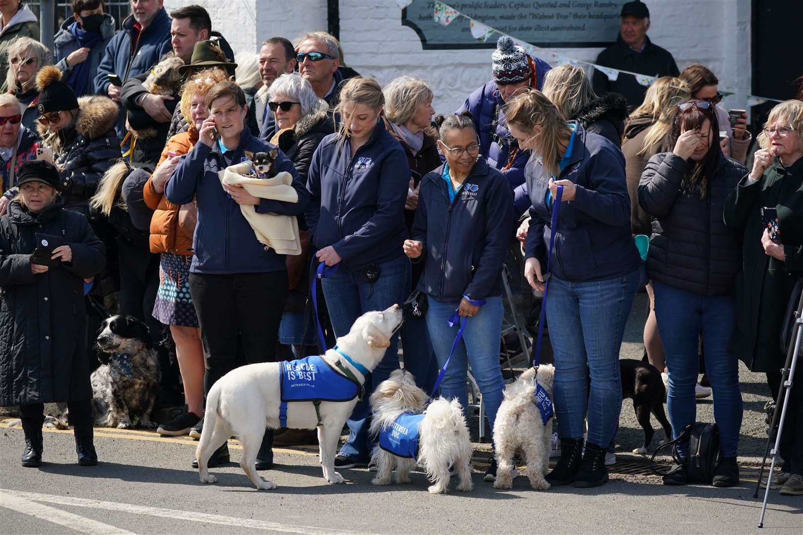 Well-wishers lined the streets of Paul O’Grady’s home village of Aldington, many of them accompanied by their dogs (Yui Mok/PA)