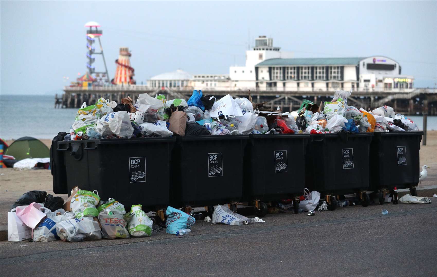 Waste ready to be collected after a busy day at Bournemouth beach (Andrew Matthews/PA)