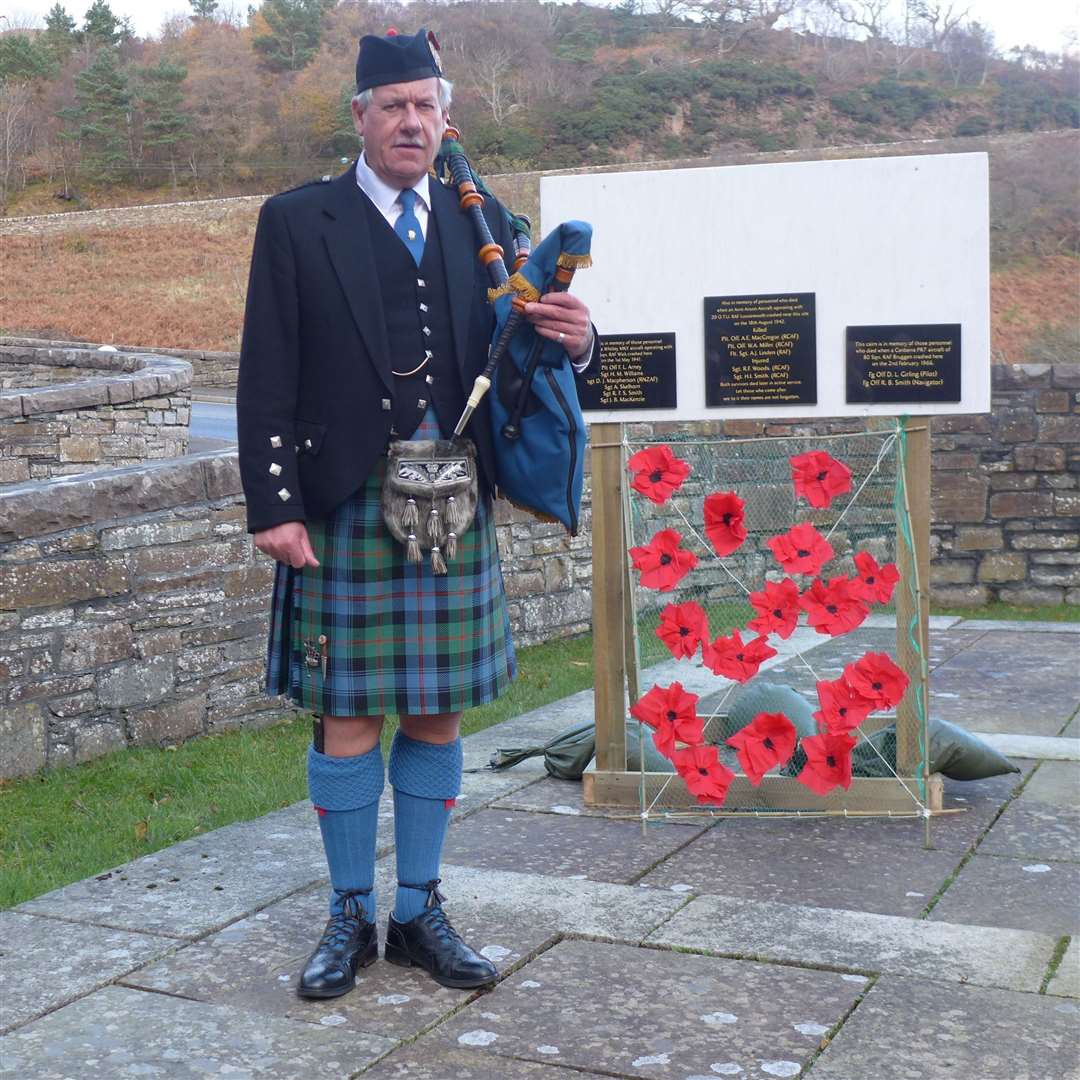 Piper Robert Wilson alongside newly commissioned Royal British Legion plaques that are to be erected on special cairns on the Scaraben hills in memory airmen who lost their lives in the area. Picture: Willie Mackay