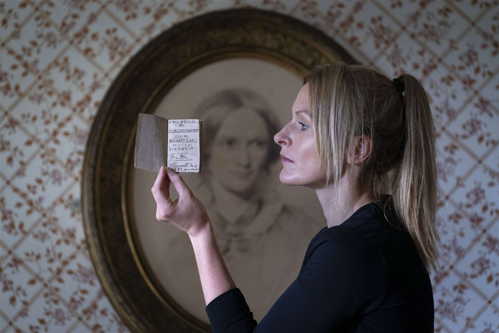 Curator Sarah Laycock with the Charlotte Bronte miniature manuscript (Danny Lawson/PA)