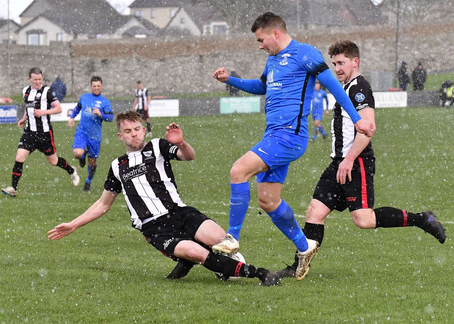A well-timed tackle by Alan Farquhar halts Strathspey Thistle's Scott Lisle during a league clash at Harmsworth Park in March 2019. Picture: Mel Roger