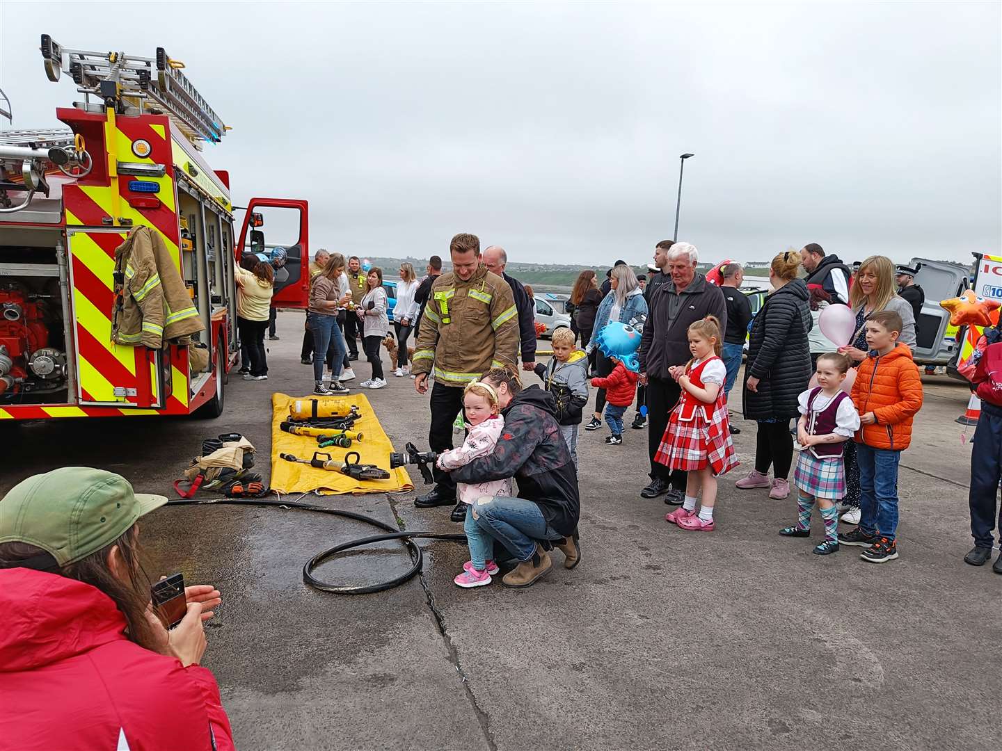 Youngsters queuing to get a close-up look at a fire engine.