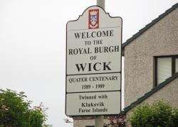 Signage at an entrance to Wick indicates its link to the Faroe Islands.