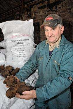 George Sutherland, of Harpsdale, with some of his Caithness peat.