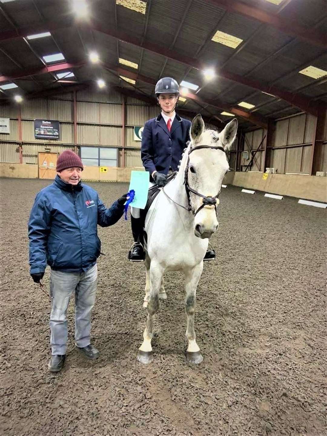 Dressage judge Stephen Cruickshank presents Liam Mackenzie with his rosette after he won the grassroots test. Liam had the highest percentage of the day and qualified in both of his tests for the Barrier Spring Festival with Wee Vintage Annie.