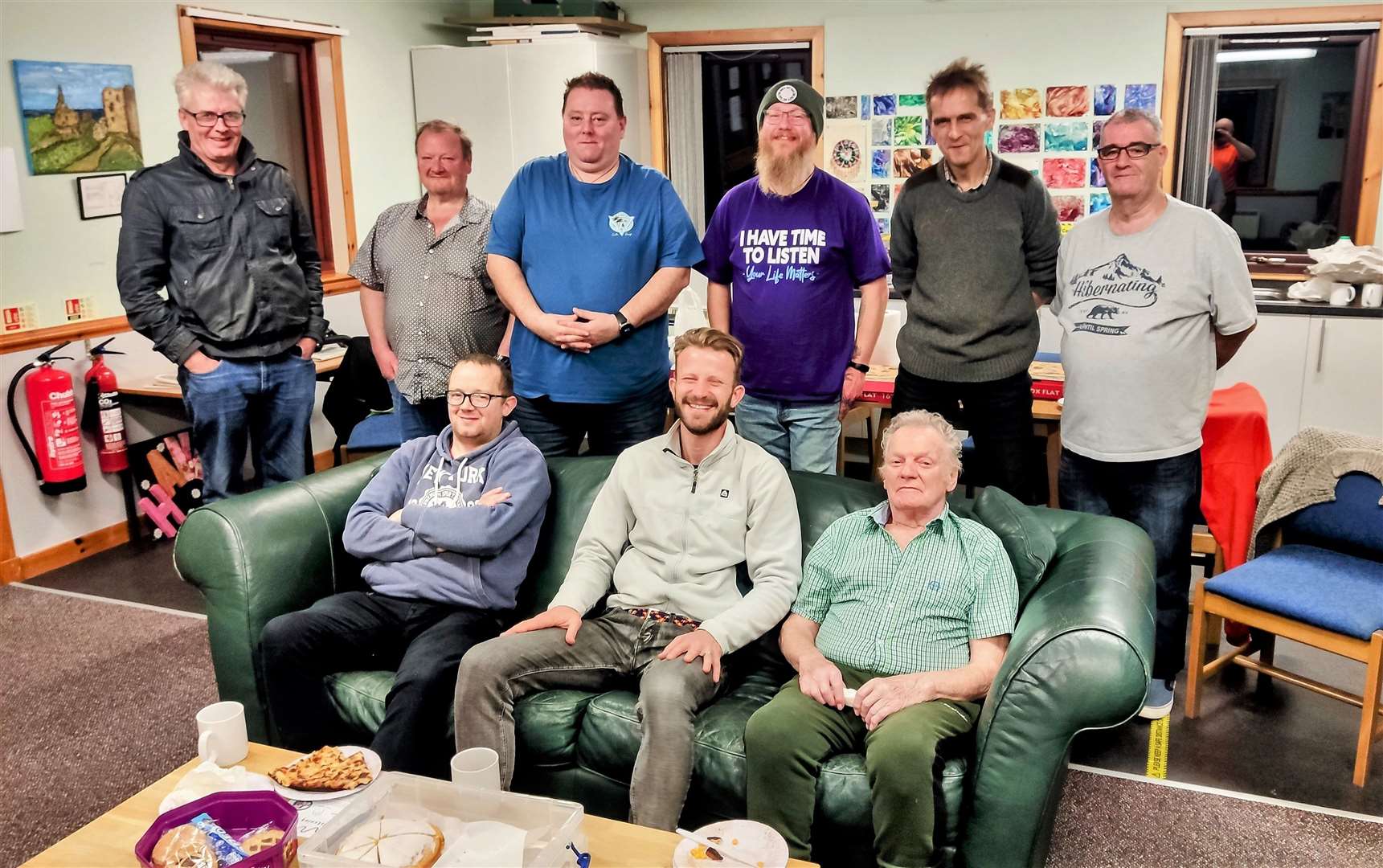 Andy Caine, seated centre, with members of the JiM group at the Haven in Wick.