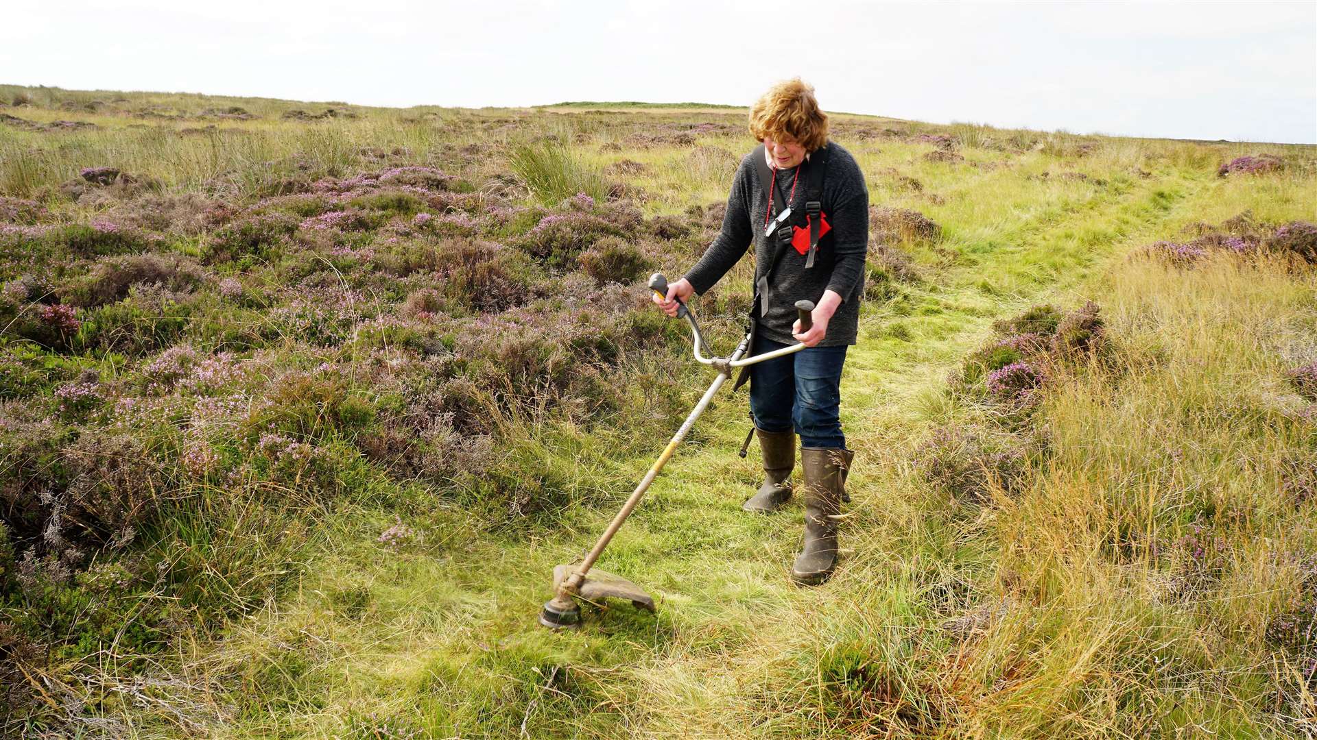 Landowner Islay Macleod strims a path for easier access to the site.