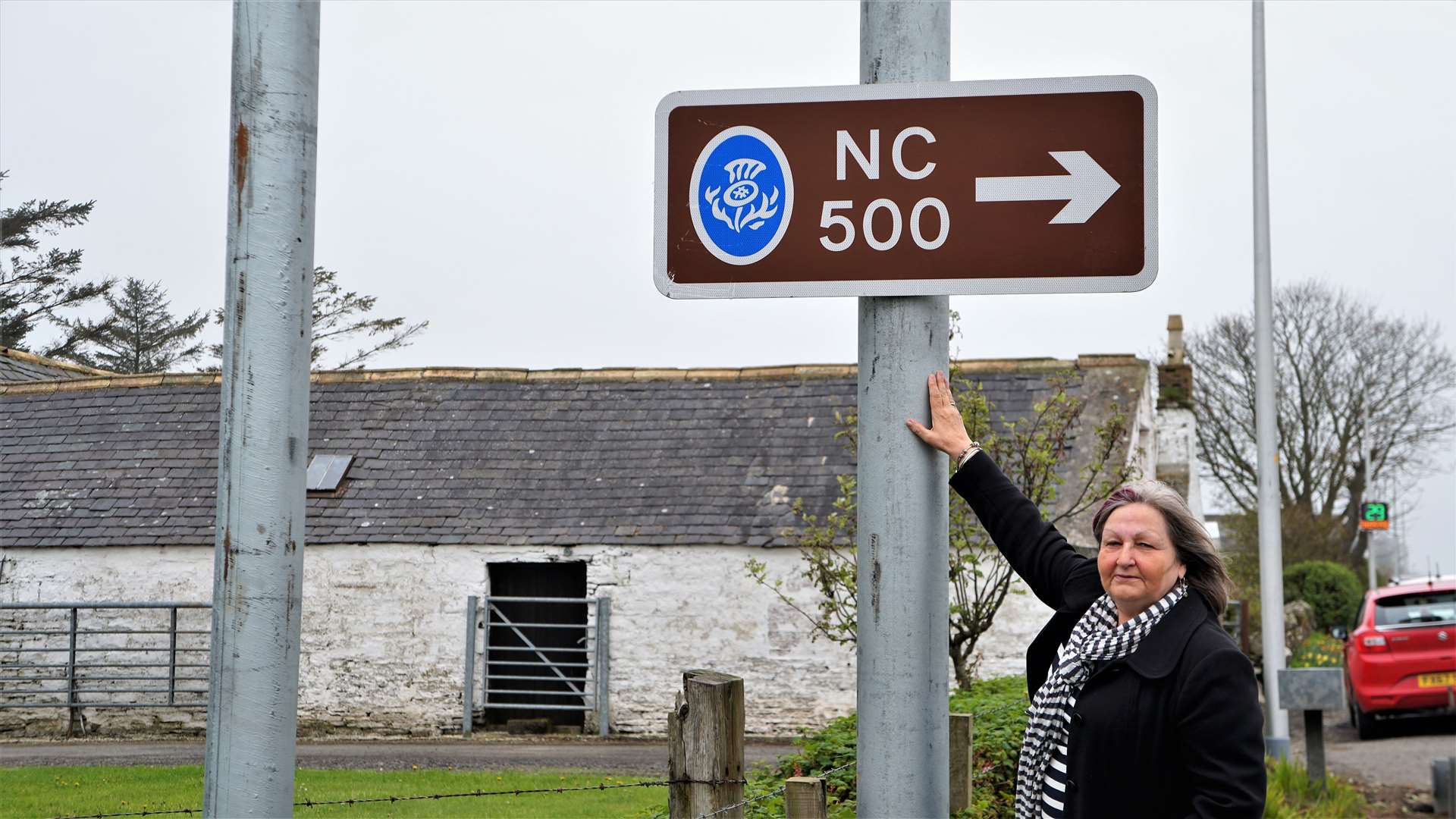 Jan McEwan at the road sign which was recently put back up on the A99 to inform drivers of the turning to John O'Groats. Picture: DGS