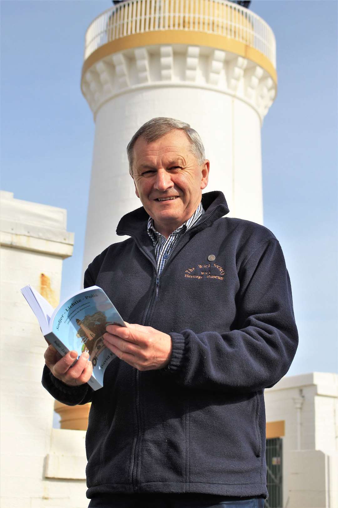 David Fraser with his book at Noss Head lighthouse.