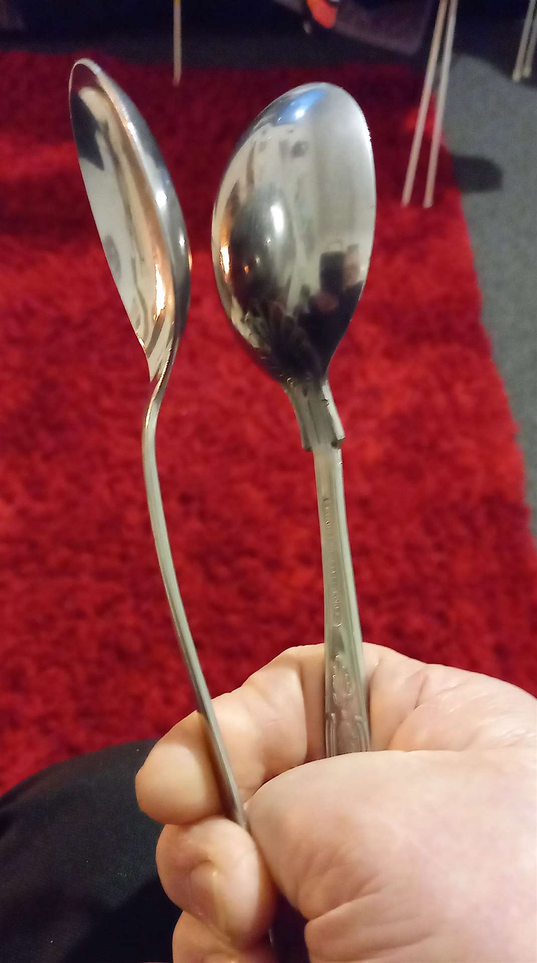 Willie's spoons were bought for 10p each in a local charity shop. In this photo he shows how to hold them.