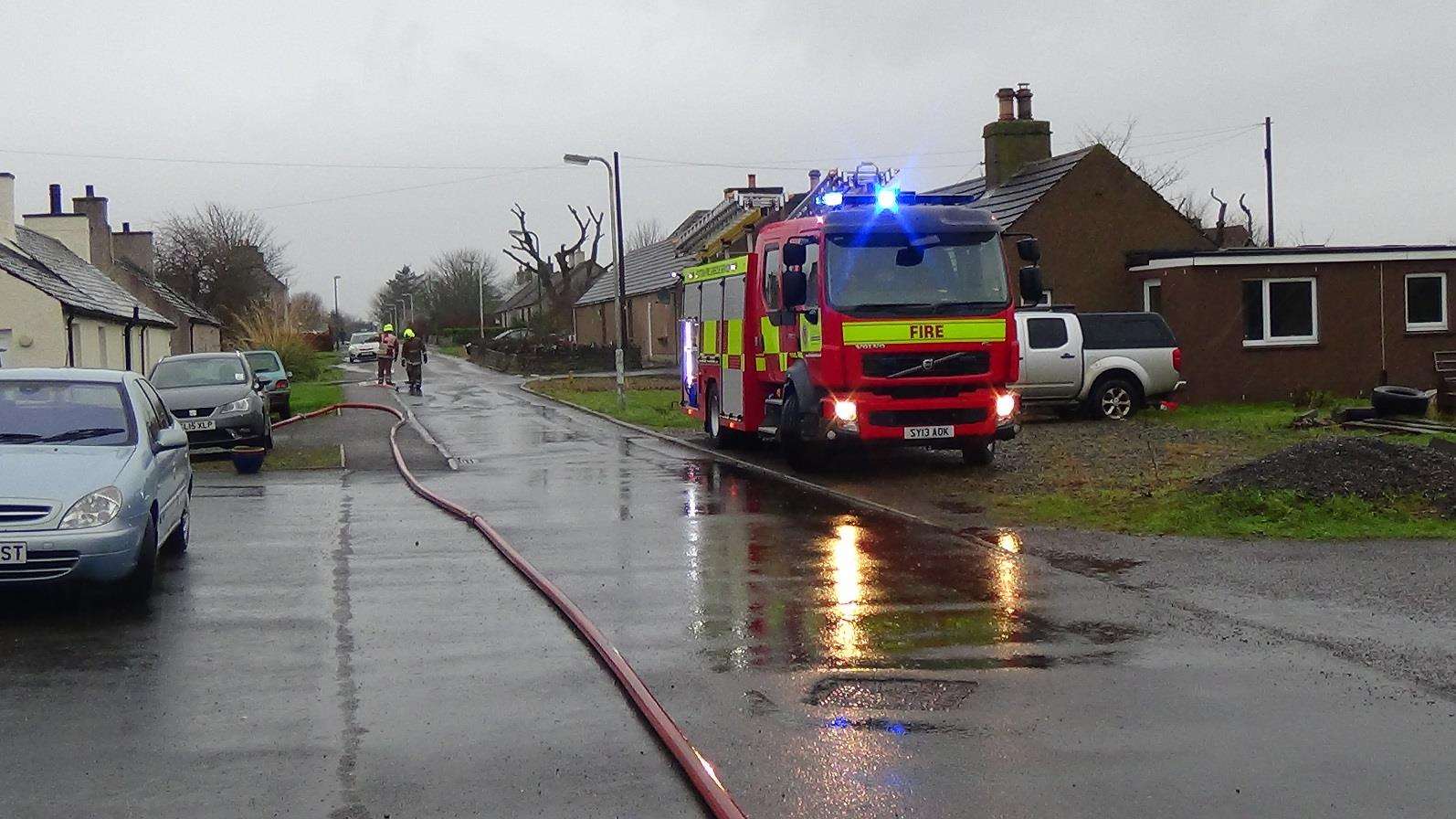 Fire crews spent Sunday pumping water out of Church Street, Halkirk. Photo: Will Clark.