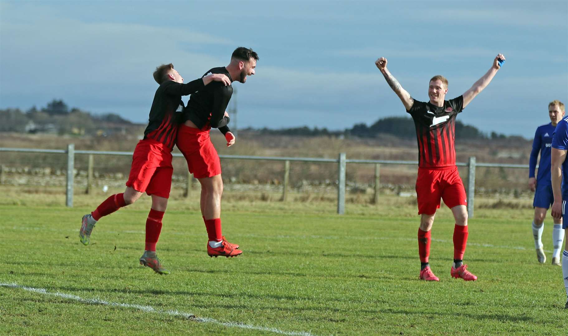 Ryan Sutherland (centre) jumps for joy with Sam Barclay after scoring Halkirk United's opening goal against Invergordon on Saturday, while Aidan Reid raises his arms in celebration. Picture: James Gunn
