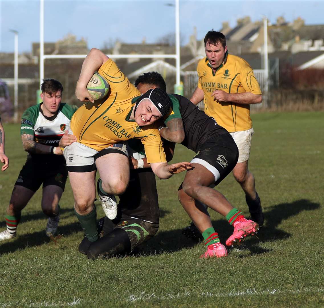 Callum Clark tries to squeeze his way through the Highland 3rd XV defence. Picture: James Gunn