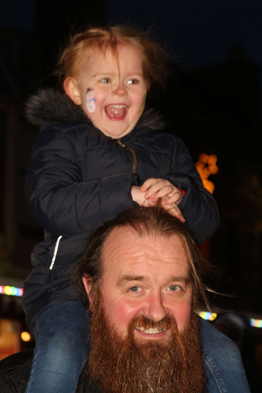 Paisley Macdonald's face says it all – she really enjoyed the moment the Christmas tree lights were switched on. Dad Gordie makes sure she gets a good view. Picture: Eswyl Fell
