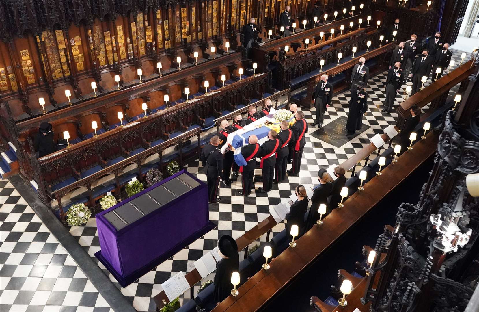 The Queen watches as pallbearers carry the coffin of the Duke of Edinburgh during his funeral at St George’s Chapel, Windsor Castle, Berkshire (Dominic Lipinski/PA)
