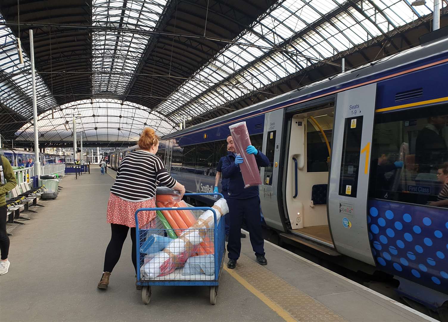 ScotRail staff at Glasgow Queen Street helping to load fabric onto an Inverness-bound train on Friday.