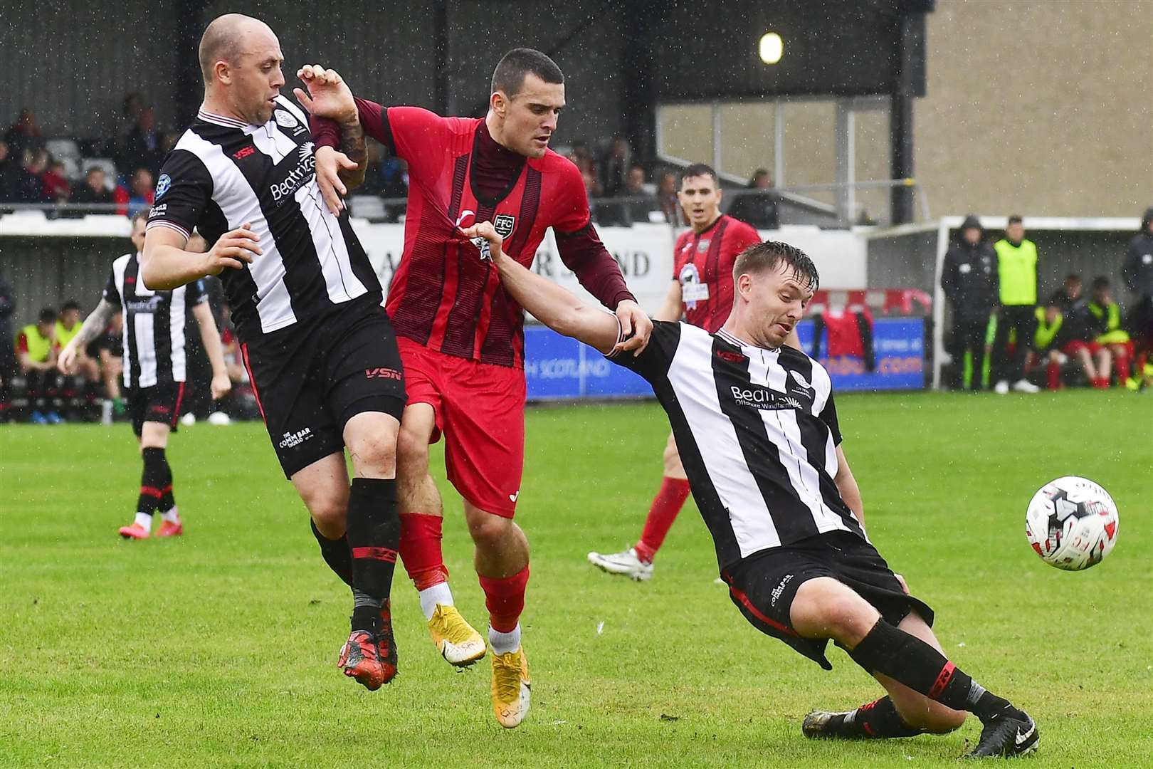 Wick Academy defender Andrew Hardwick (right) clears the danger from Fraserburgh's Scott Barbour, with Danny Mackay in close attendance. Picture: Mel Roger