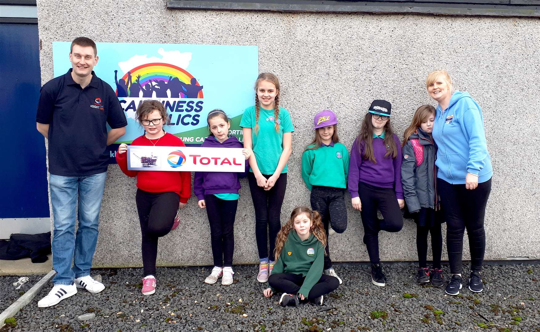 Andrew Gunn, pictured left, represented Total's Alwyn North oil platform along with project manager Wendy Thain, far right, and some of the Caithness Klics kids.