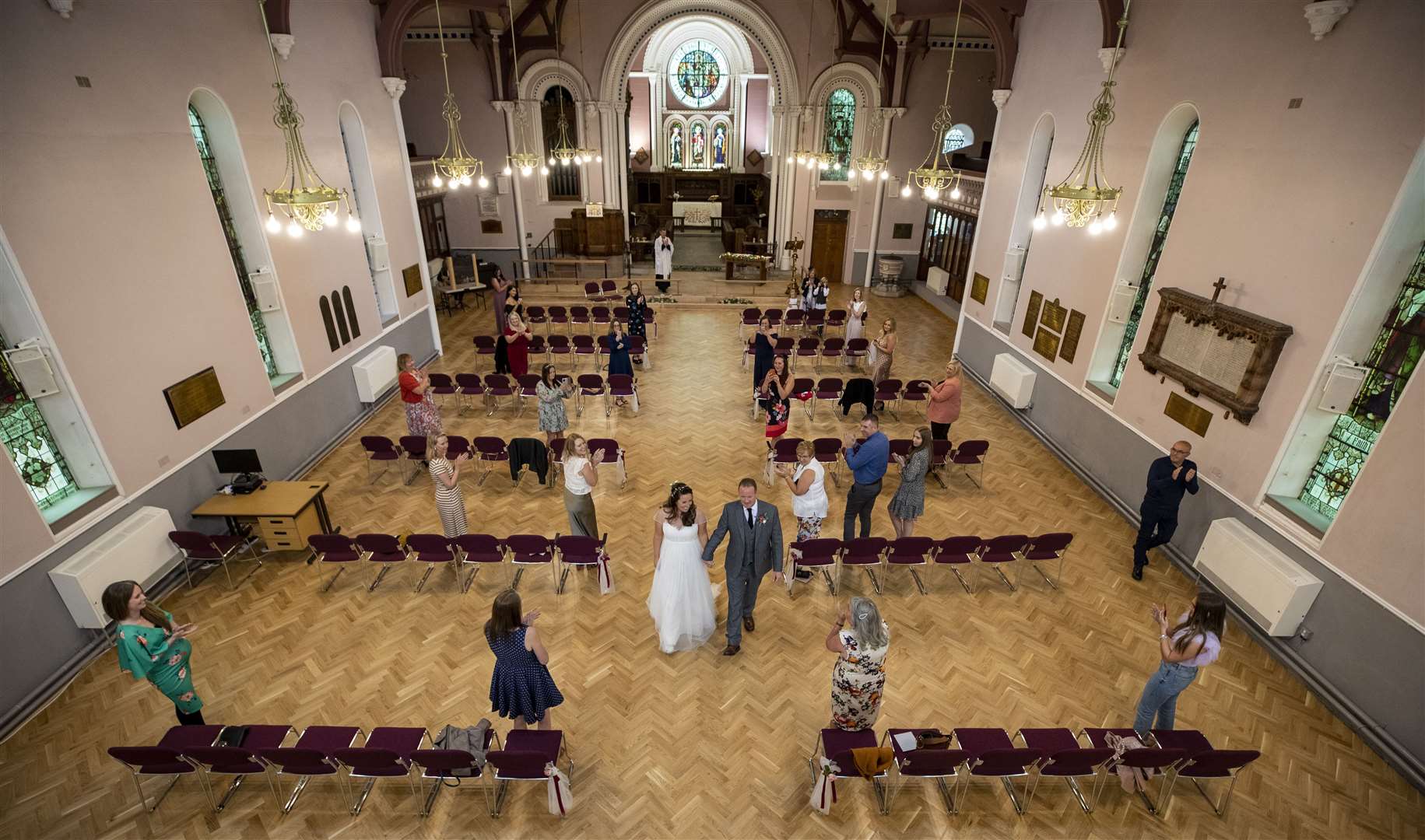 Guests socially distance at a wedding during the pandemic (Peter Byrne/PA)