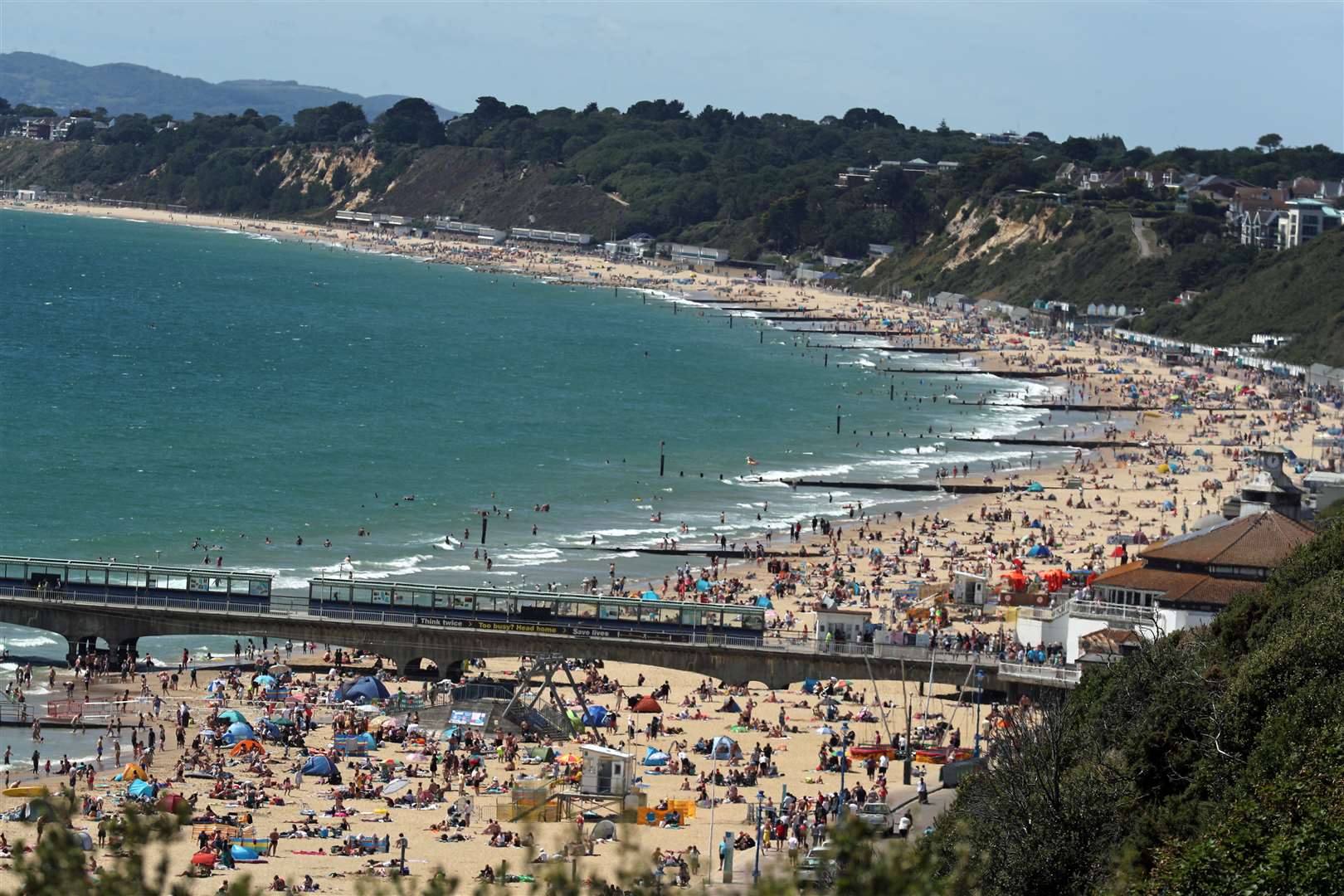The start of the month saw crowds flock to Bournemouth beach – as temperatures reached the mid-30s (Steve Parsons/PA)