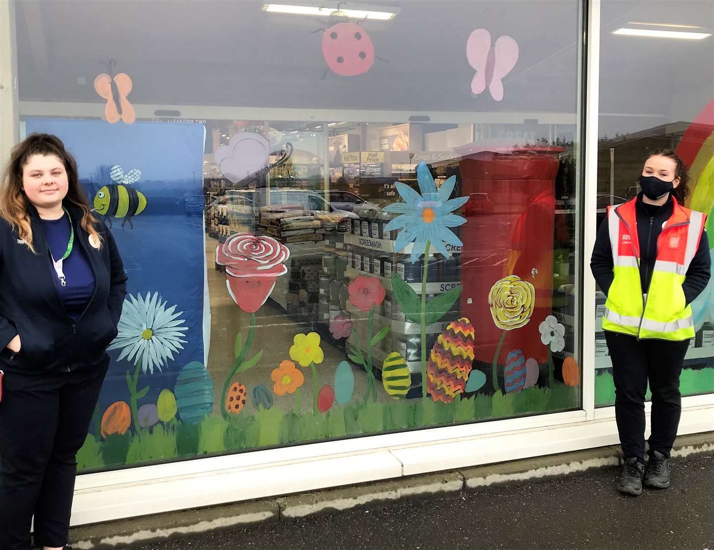 Tesco Wick staff with colourful artwork currently gracing the front of the store.