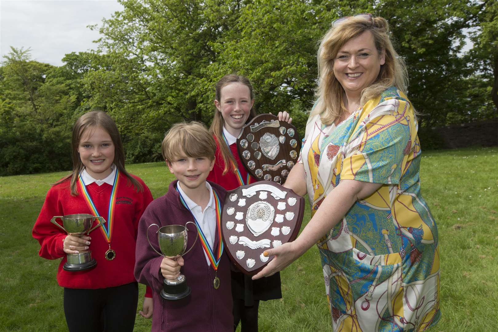 The Thurso and District Round Table Shield, the overall trophy for verse speaking, was won by Oliver Hall, receiving the trophy from adjudicator Rebecca Vines. Oliver also won the Stroma Cup in the P5 section, while Emily Sutherland (left) won the Edgar Cup for P7 and Emily Mackenzie received the Wick Town Improvements Shield for P6. Picture: Robert MacDonald / Northern Studios