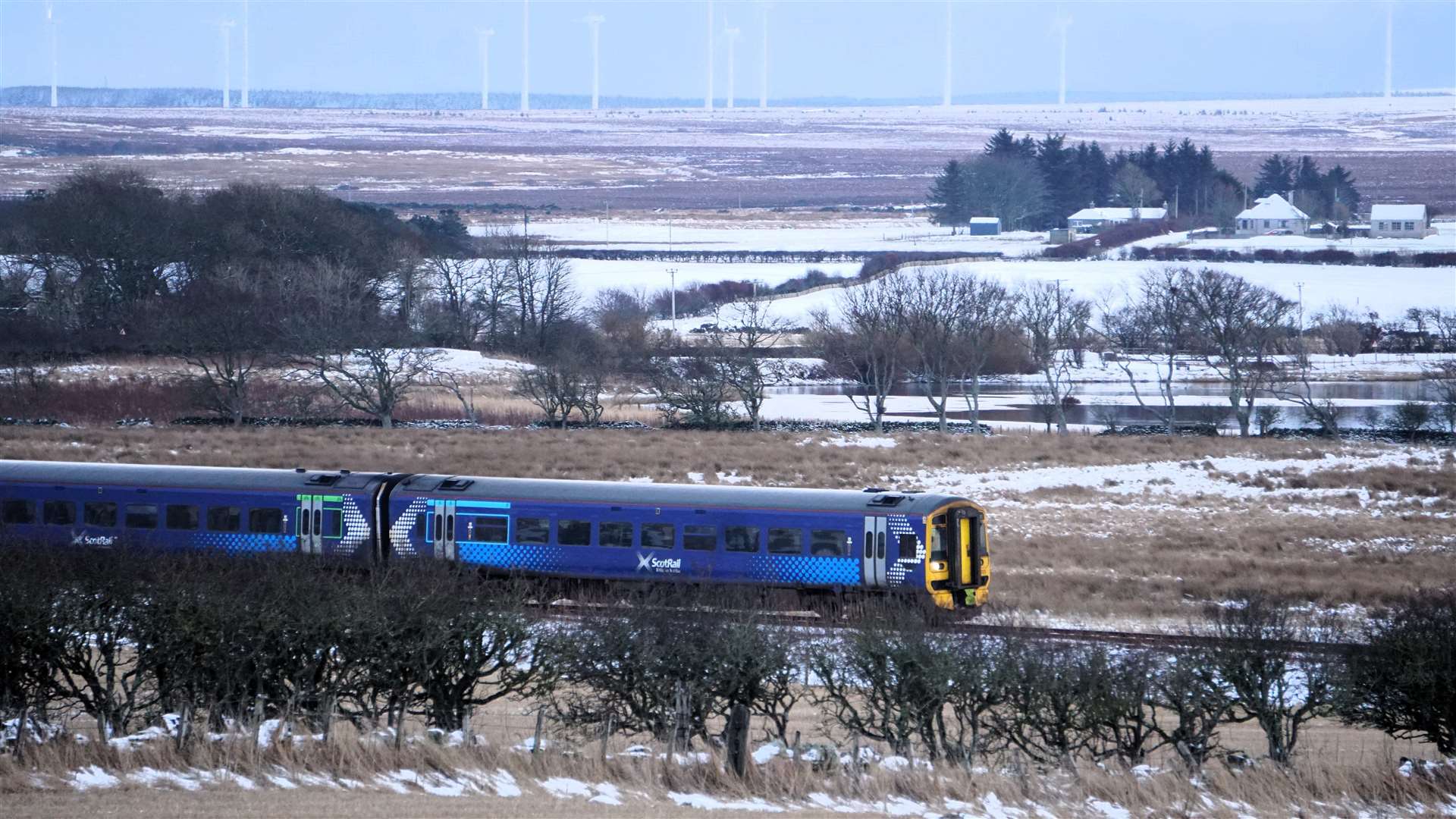 Train in snow passing by Watten loch, February 8, 2024. Picture: DGS