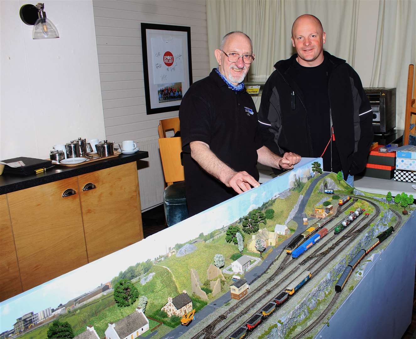Neil Ellison from Forres beside his model railway, along with visitor William McKenzie. Picture: Alan Hendry