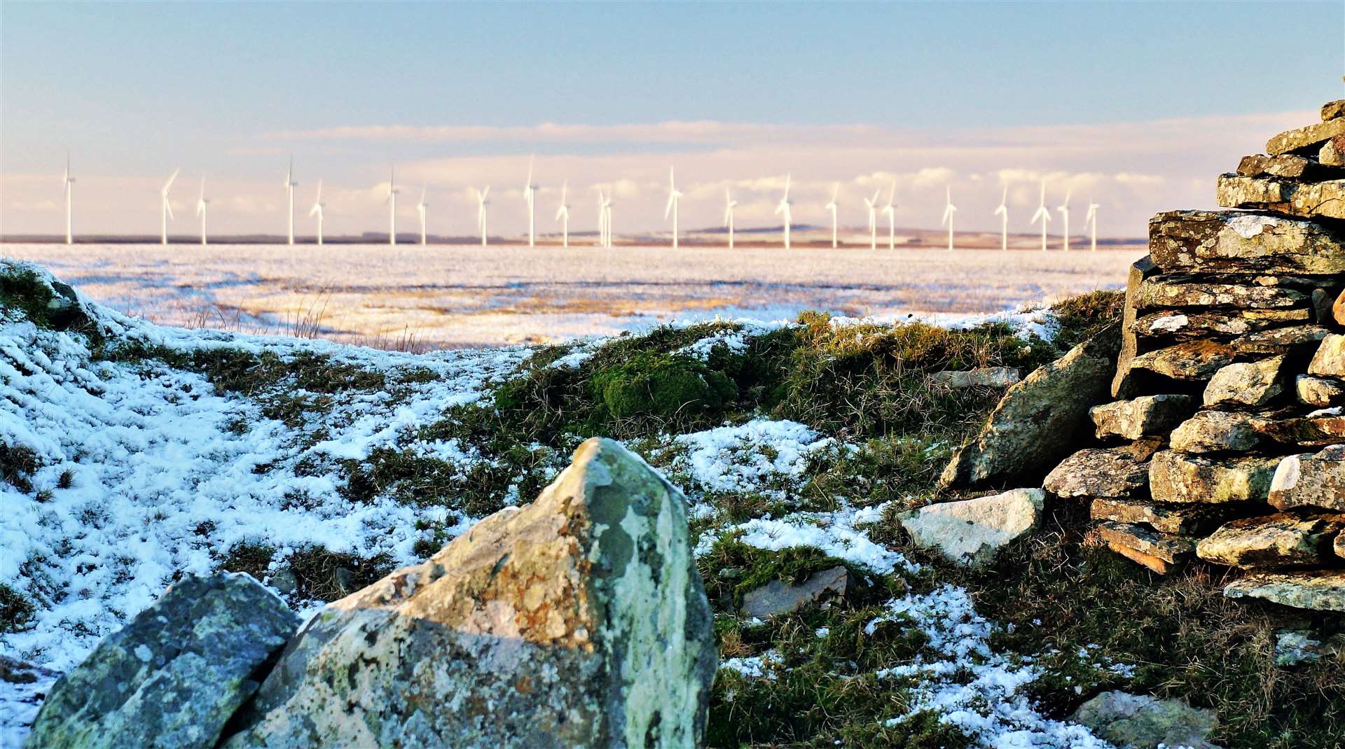 Neolithic long horned cairn at Yarrows with wind turbines in the distance. Picture: DGS