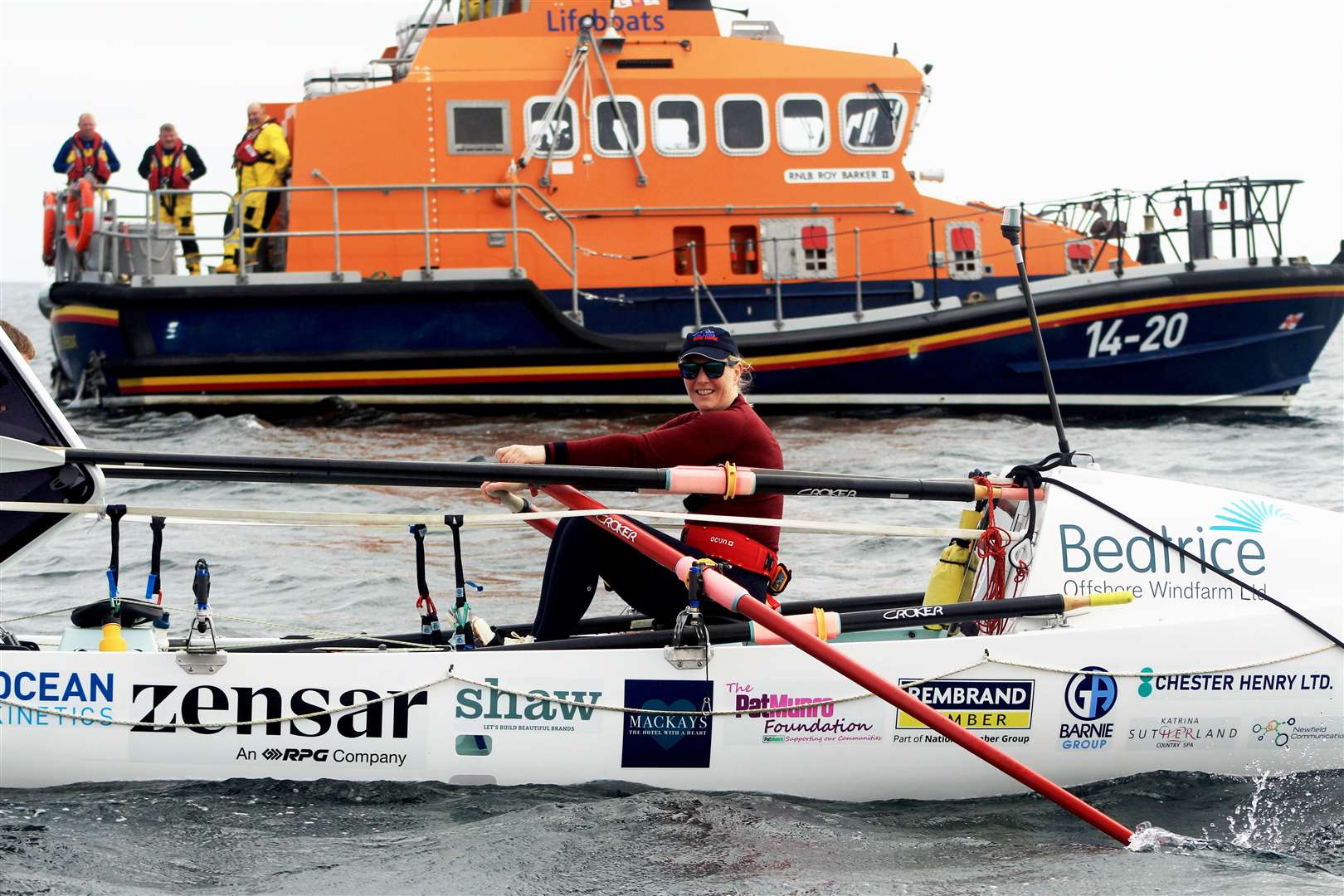 Mhairi at the oars with the Wick lifeboat behind. Picture: Alan Hendry