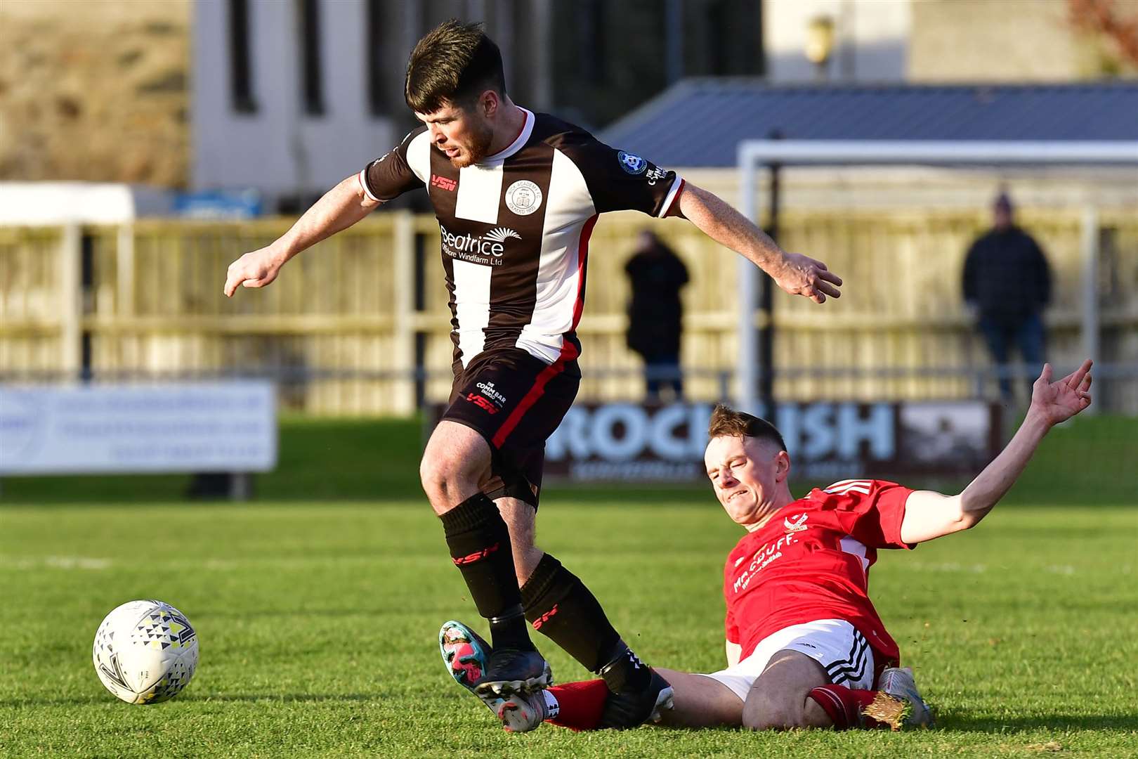 Sean Campbell of Wick Academy beats a challenge from Deveronvale's Scott Thomson. Picture: Mel Roger