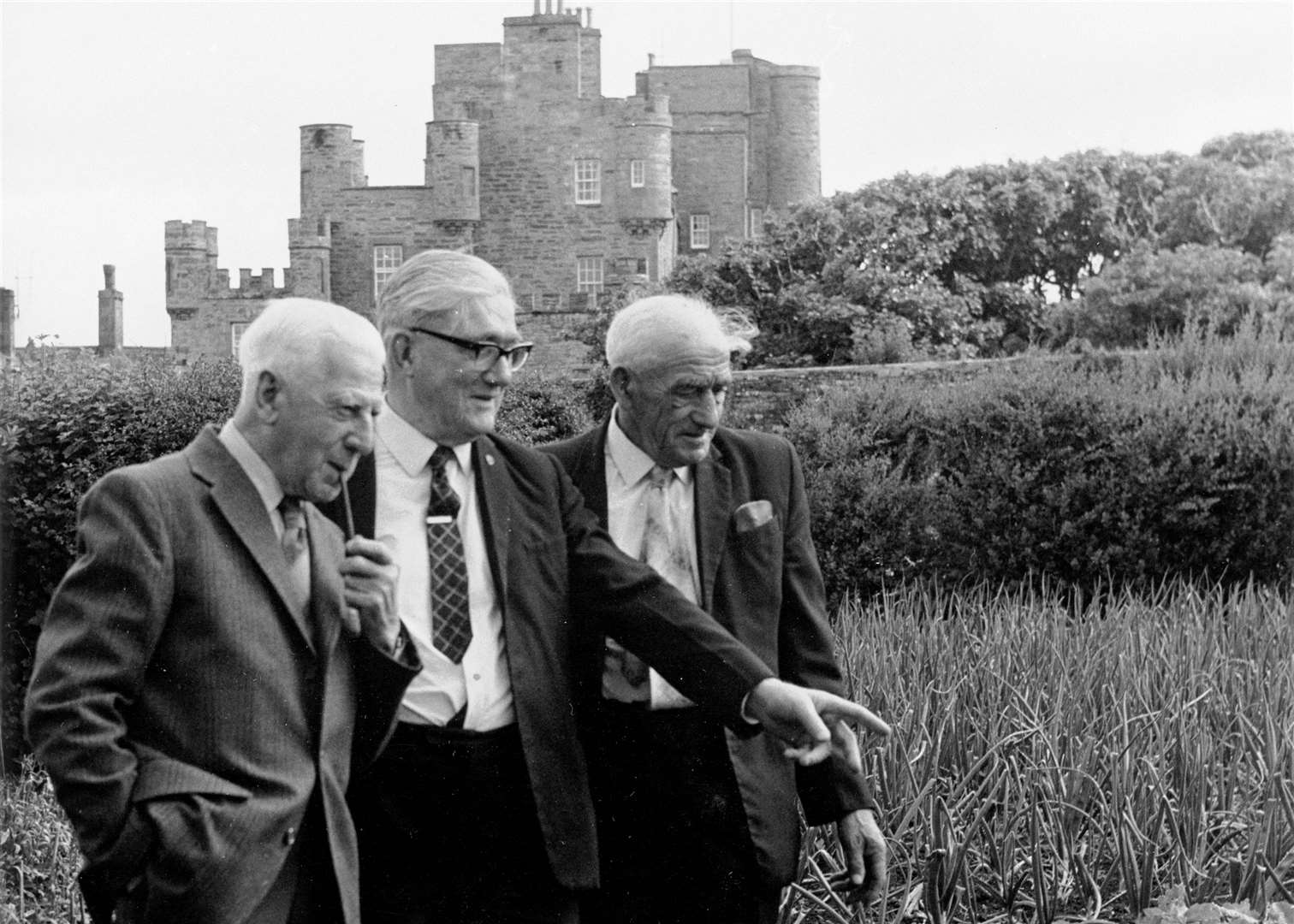 Retired members of the Dounreay Sports and Social Club were invited to visit the grounds and gardens of the Castle of Mey in 1977. From left: Walter Davie, Harry Adams and John Harper inspecting the vegetable plots. Jack Selby Collection / Thurso Heritage Society