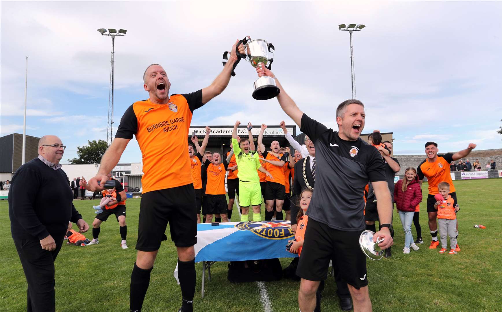 Twin brothers Keith (left) and Colin Mason lift the Highland Amateur Cup after Avoch's 1-0 victory over Wick Groats. Club captain Colin was injured and couldn't play in the final. Keith was captain on the day. The trophy was presented by Hugh Morrison, chairman of the Scottish AFA Highland Executive (left), and Iain Cowden, president of the Scottish AFA. Picture: James Gunn