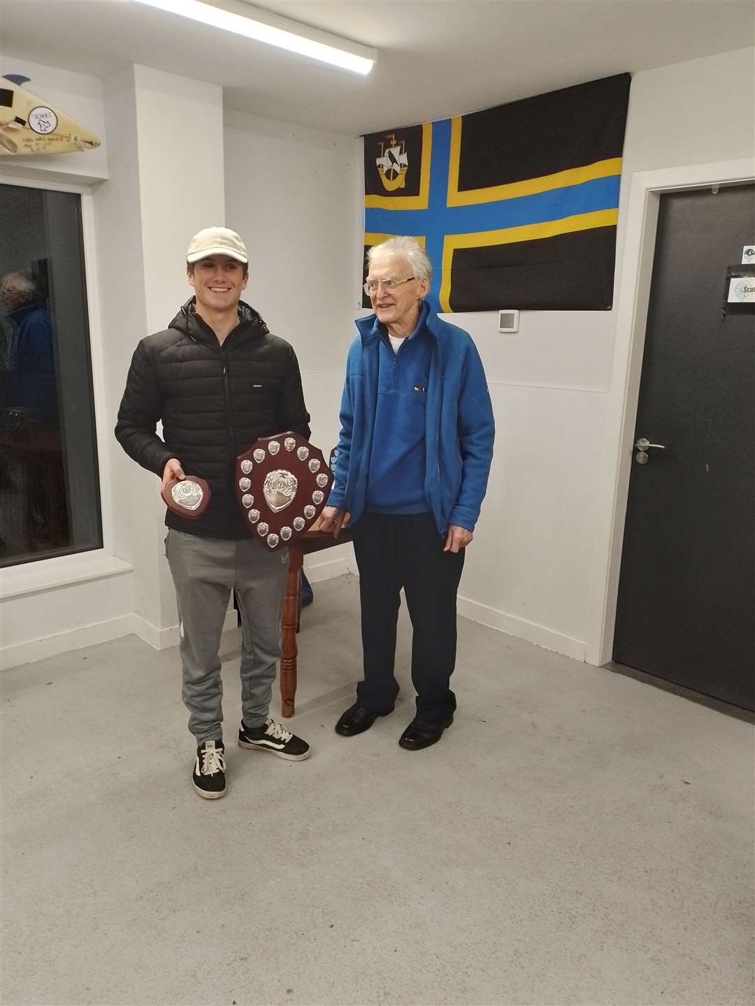 Caithness Sports Council chairman Bill Robertson hands over the Caithness Sportsman of the Year award to teenager surfer Craig McLachan