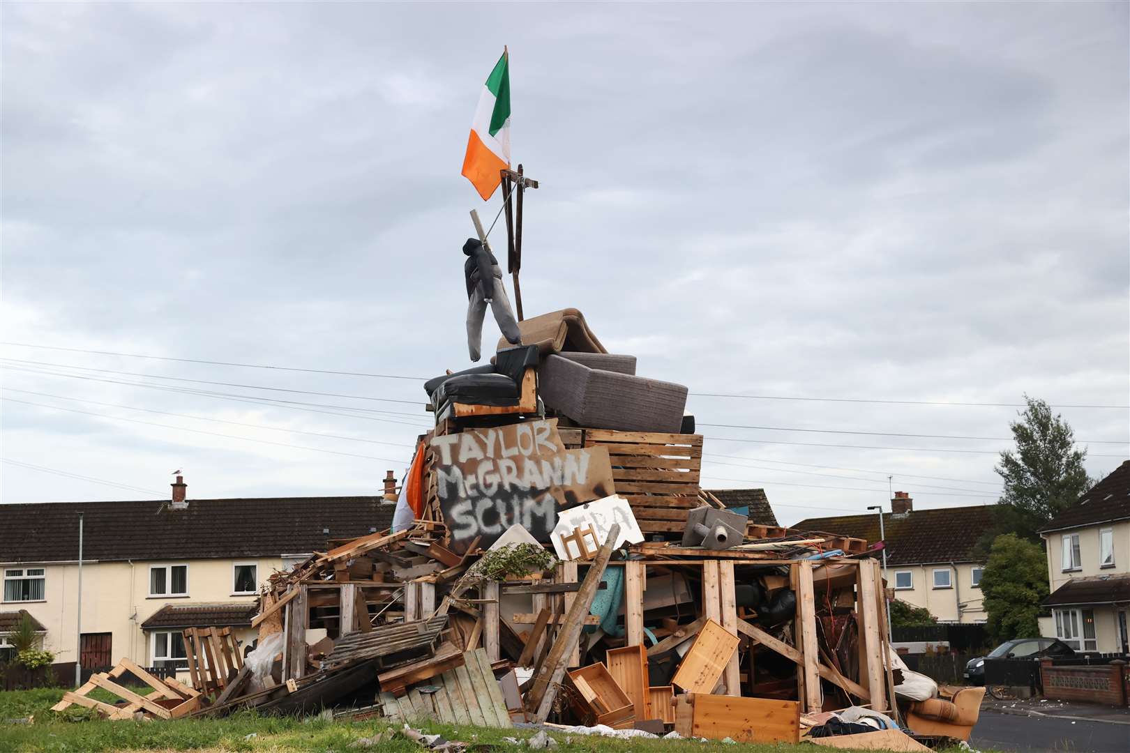 An effigy above a poster with the name of Sinn Fein councillorTaylor McGrann appeared on a bonfire in Newtownabbey (PA)