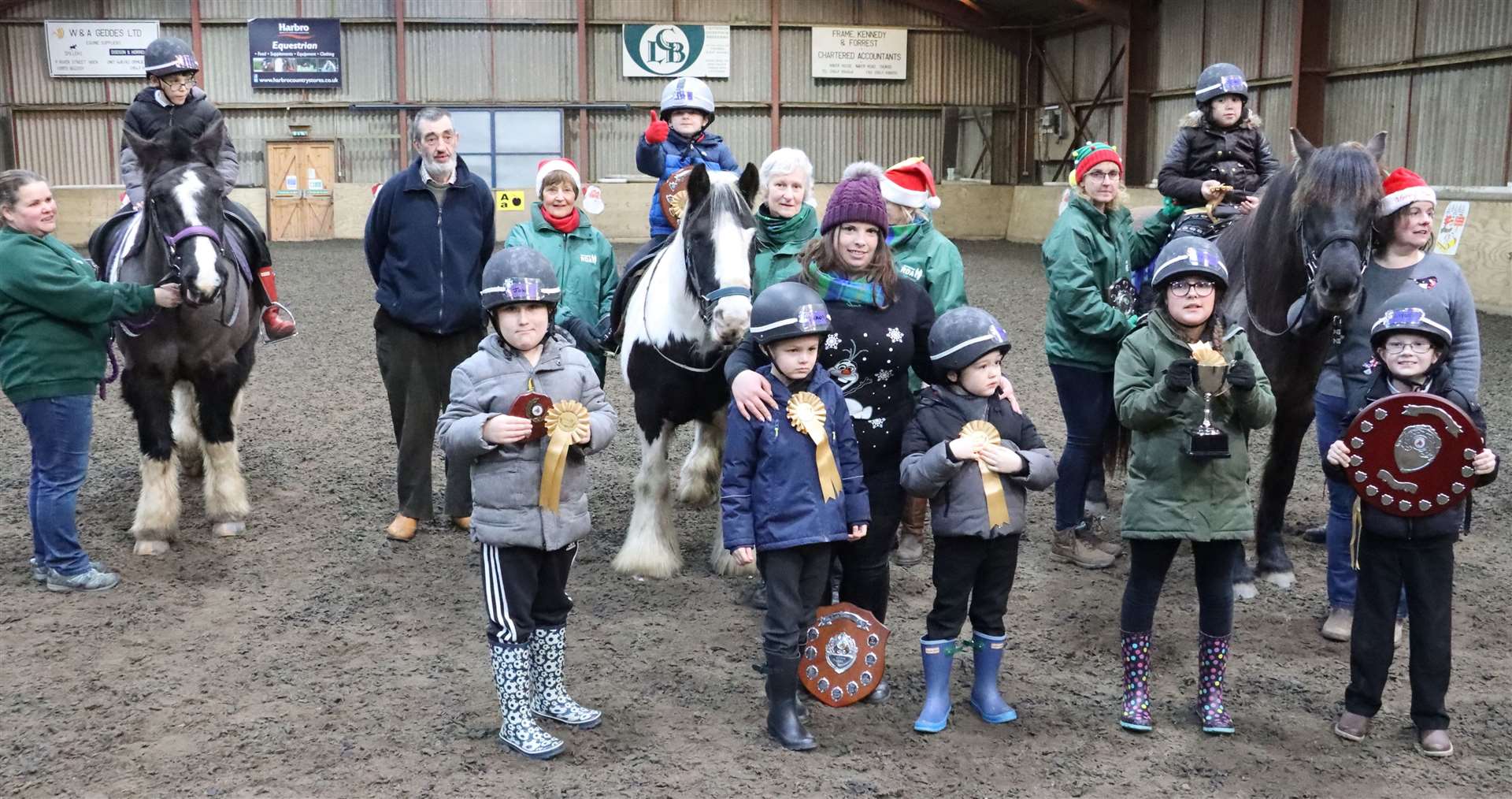 Coach Leeann Hope with the prize winners from Ride 4. In the background is Ian Campbell, Todholes, who handed over a new shield to the group in memory of his mother Monica Campbell. Picture: Neil Buchan