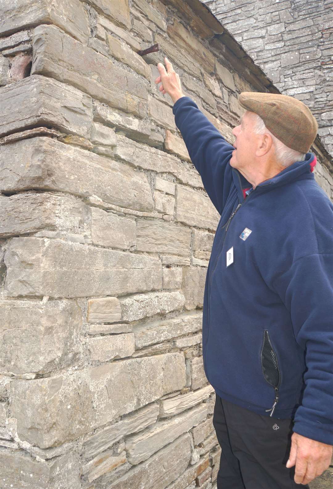 David Glass from a local history group points out where the jougs would have been sited on Old St Peter's Kirk in Thurso. The jougs consisted of an iron ring that the offender would be fastened to and publicly shamed. Picture: DGS