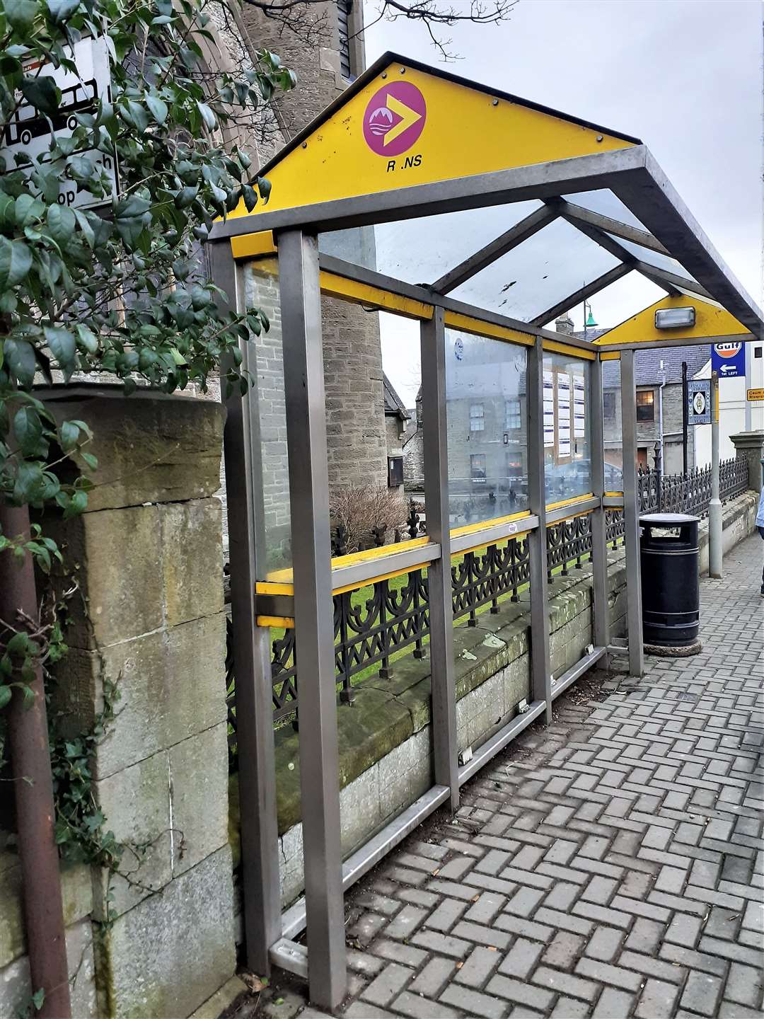 Panels are missing from this bus shelter.