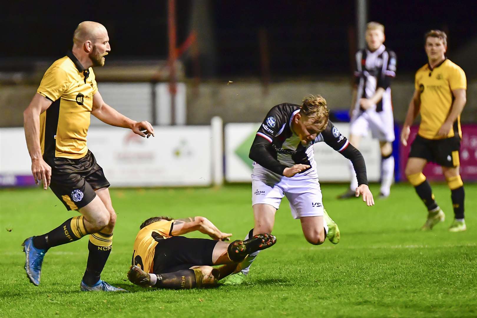 Mark Macadie of Wick Academy is brought down by Nairn's Wayne Mackintosh. Picture: Mel Roger