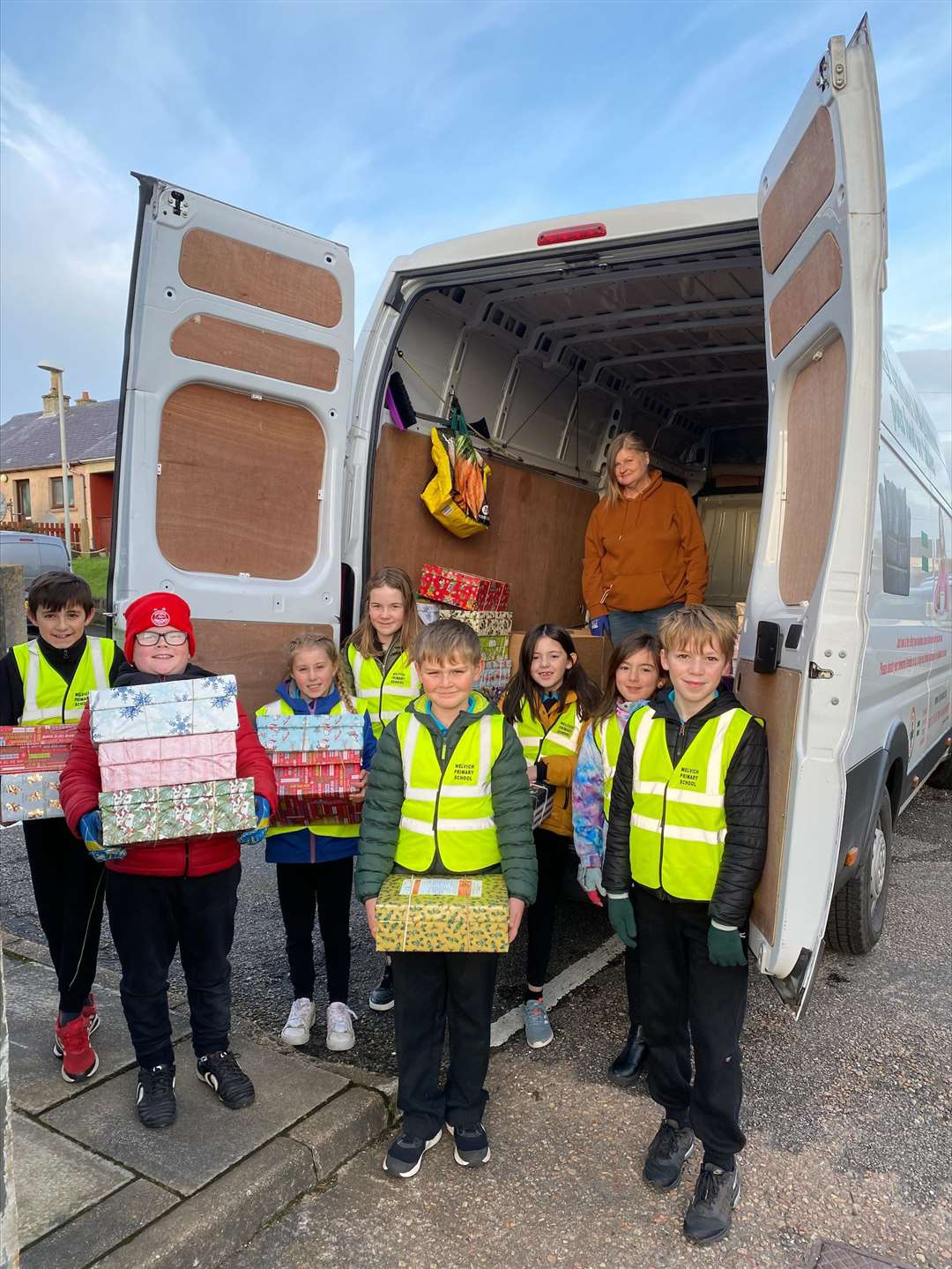 Melvich Primary Pupil Council helping to load the boxes onto the Blythswood collection lorry.