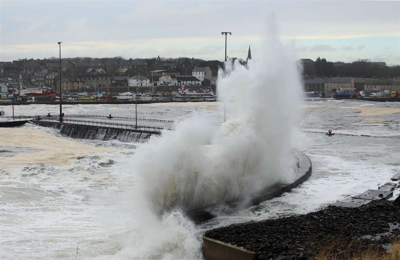 Waves crashing against the harbour quay on the north side of Wick Bay, near Scalesburn. Picture: Alan Hendry