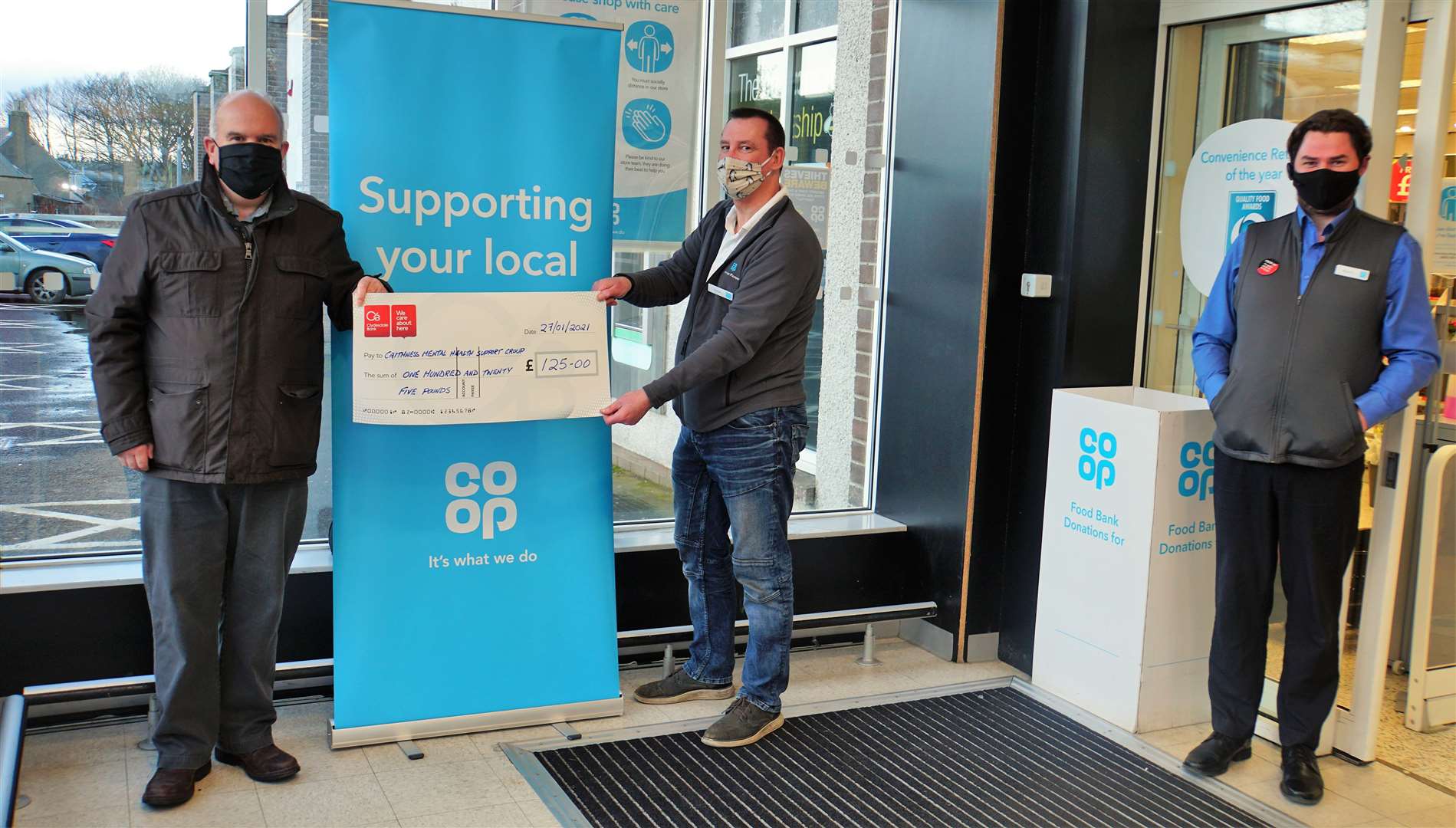 From left, Chris Mackenzie, group manager for Caithness Mental Health Support Group receiving the £125 cheque, Jamie Robson Community and Shared Value representative with the Co-op and the supermarket manager Modris Karklins. Picture: DGS