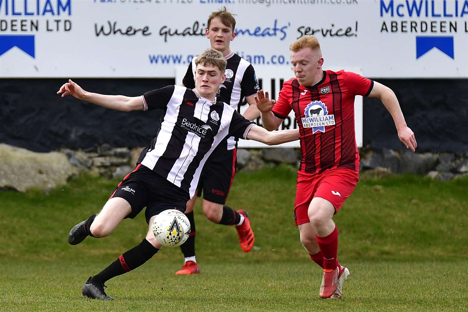 Wick's Joe Anderson about to clear ball ahead of Fraserburgh's Lewis Duncan