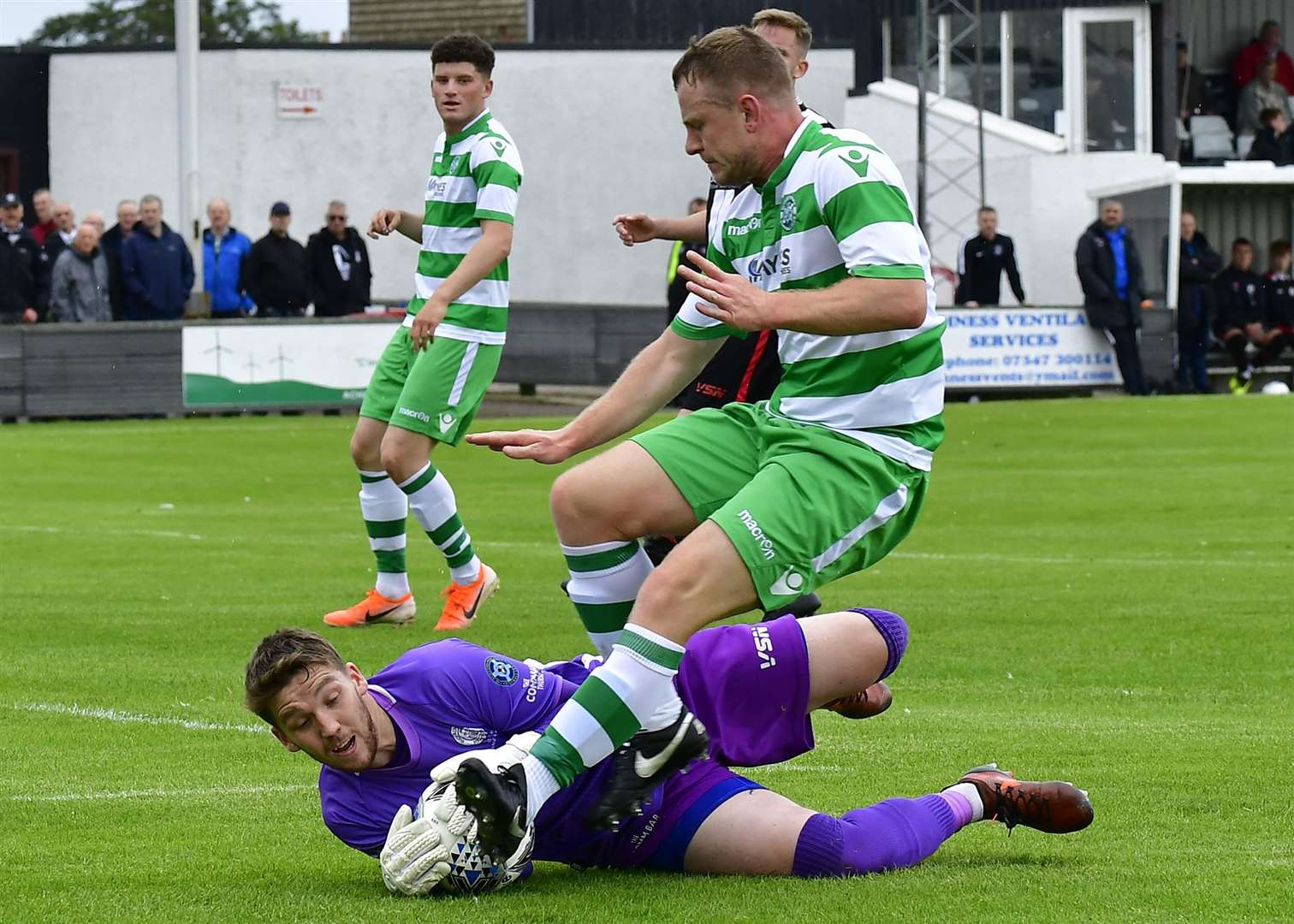 Wick keeper Sean McCarthy gathers the ball ahead of Buckie's Shaun Carroll. Picture: Mel Roger