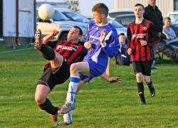 Halkirk’s Stevie Campbell clears the ball from danger with an overhead kick as Kuba Koziol closes in.
