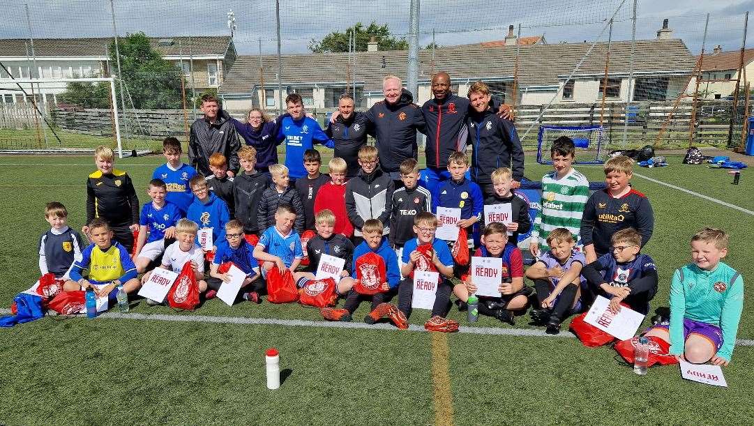 Youngsters in the 10-15 section with Alex McLeish, Marvin Andrews and the coaches from Rangers Soccer Academy.