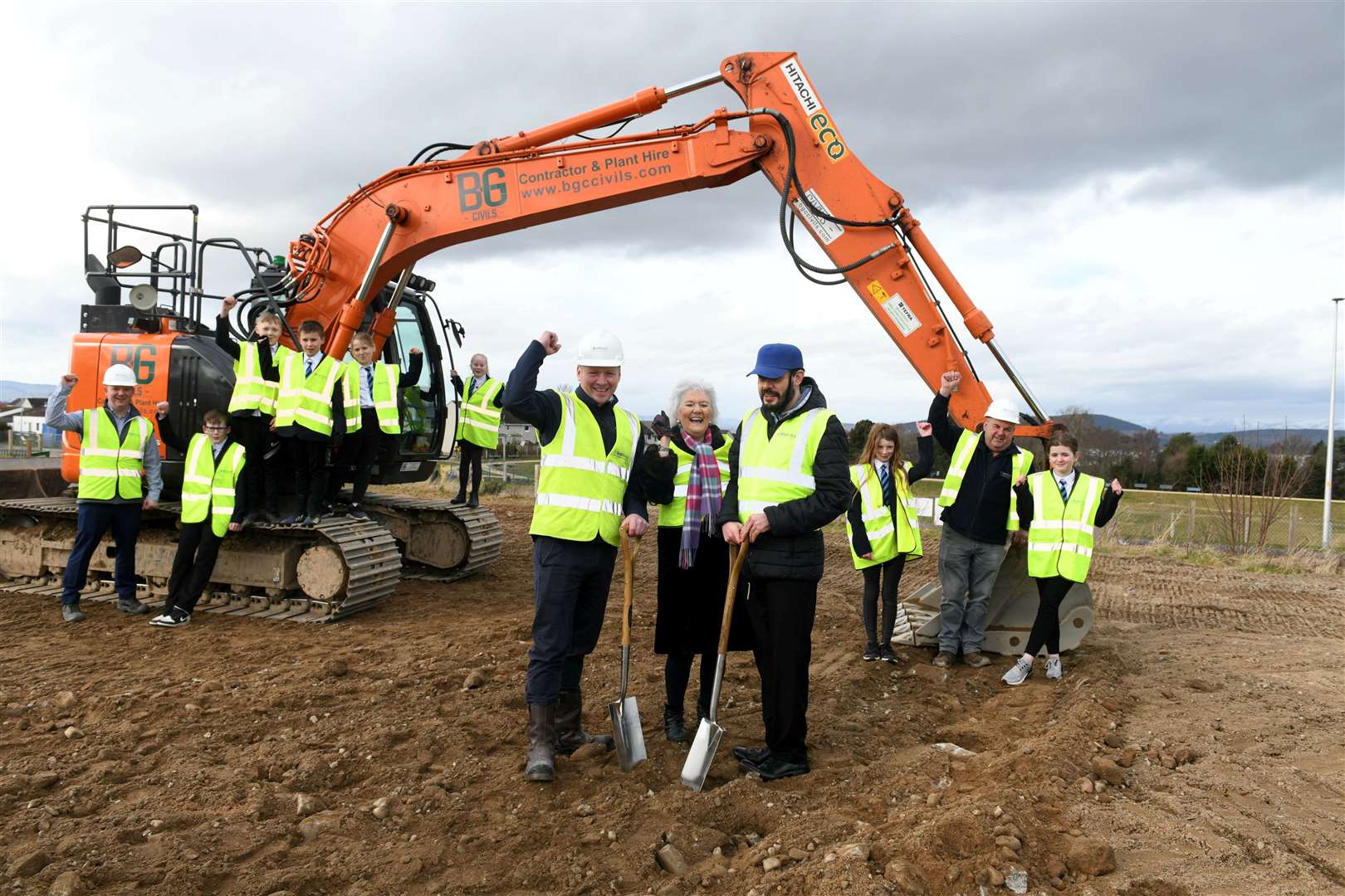 Kevin Lewis, of Compass, with Elsie Normington and son Andrew and children from nearby Smithton Primary School in Inverness, where the centre is being built.