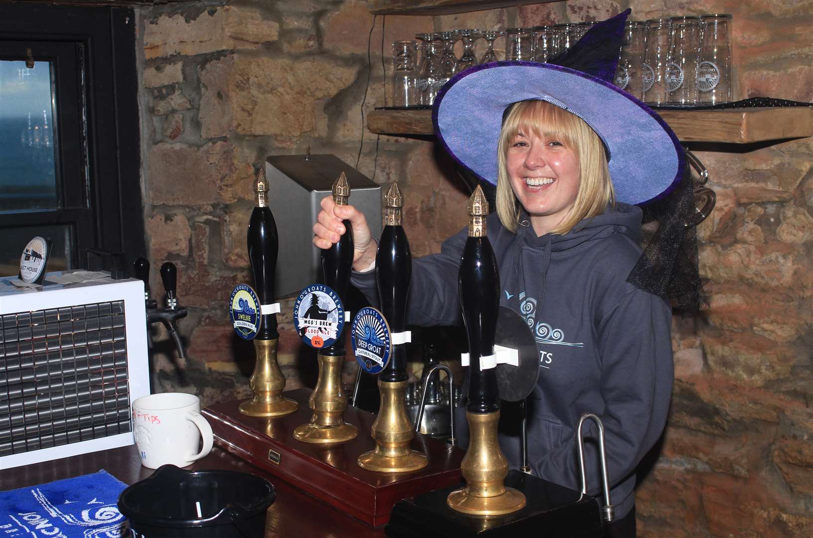 Julie Macgregor pulling a pint of a Halloween ale called Meg's Brew in the bar at John O'Groats Brewery. Picture: Alan Hendry