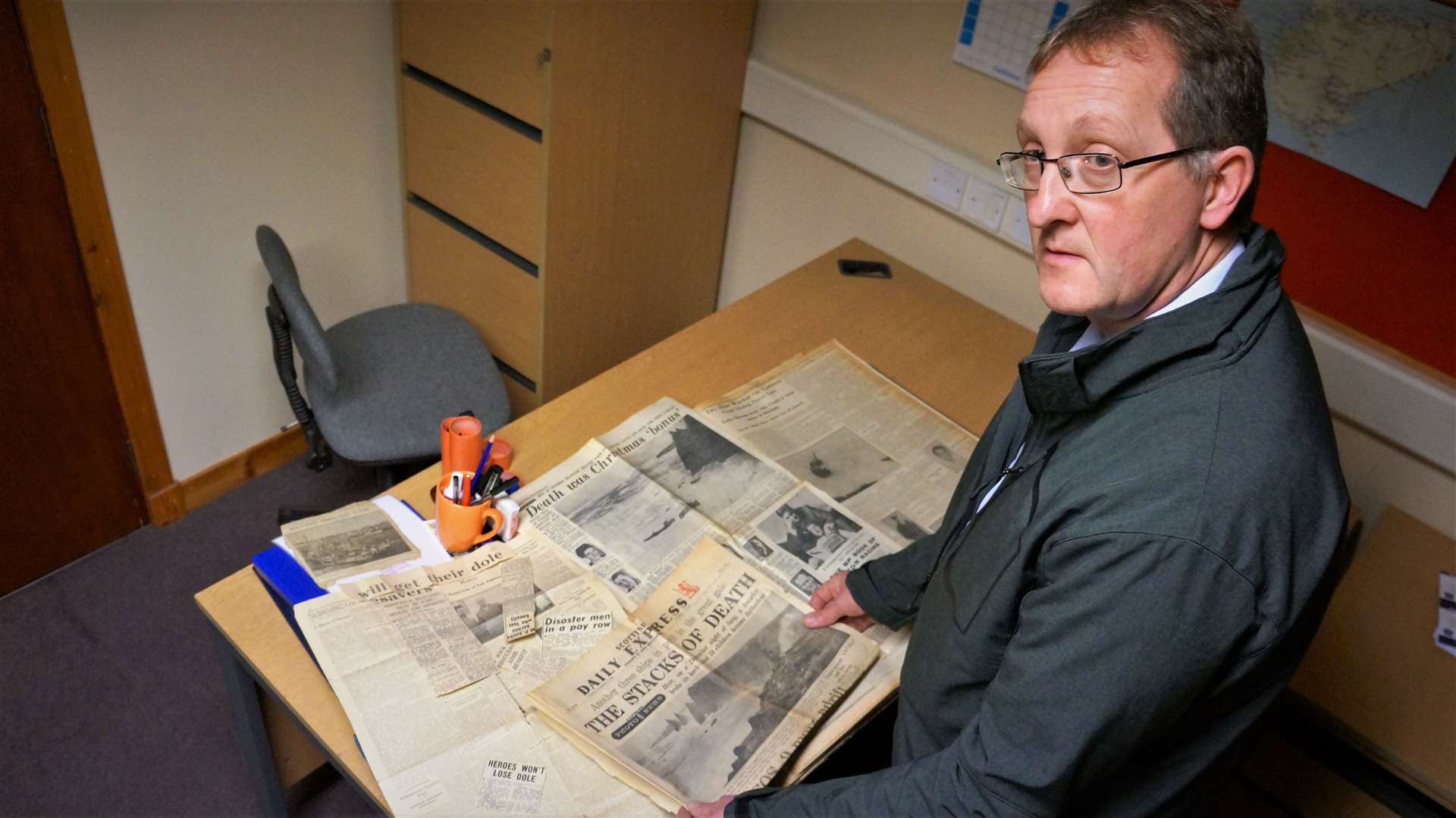 Allan Tait with some of the national and local newspaper cuttings from the George Robb disaster 60 years ago.