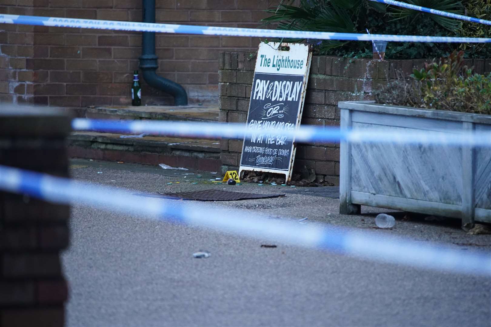 Crime scene tape and evidence markers at the Lighthouse Inn in Wallasey Village (Peter Byrne/PA)